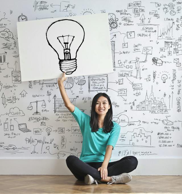 Student holding a light bulb picture.